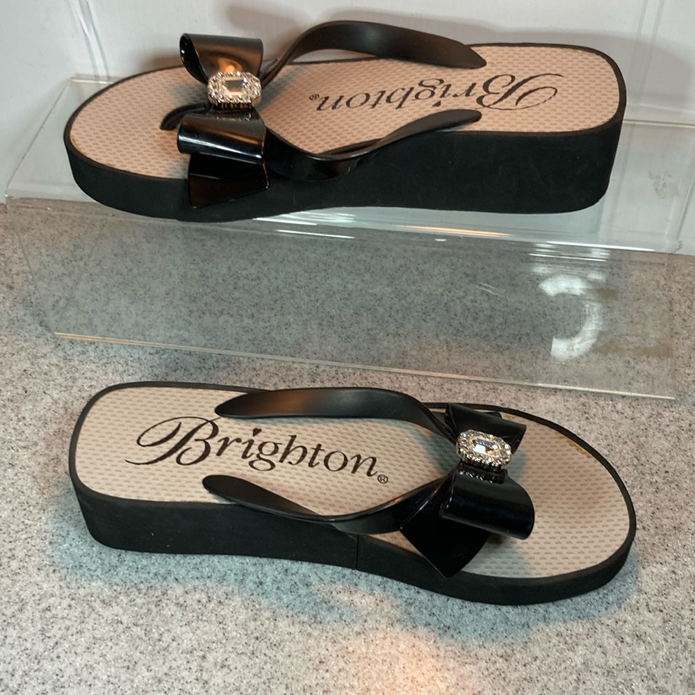 Black Brighton wedge flip flops with bow and crystal accents. Size 7 box 7‎